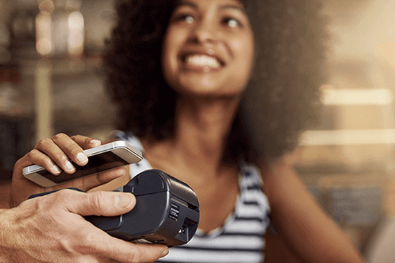 Woman Making a Contactless Payment in Restaurant